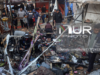 Displaced Palestinians check the damage following an Israeli strike that hits tents in Deir el-Balah in the central Gaza Strip on November 1...