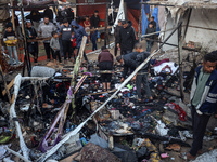 Displaced Palestinians check the damage following an Israeli strike that hits tents in Deir el-Balah in the central Gaza Strip on November 1...