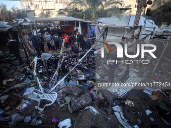 Displaced Palestinians check the damage following an Israeli strike that hits tents in Deir el-Balah in the central Gaza Strip on November 1...