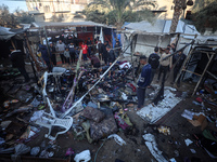 Displaced Palestinians check the damage following an Israeli strike that hits tents in Deir el-Balah in the central Gaza Strip on November 1...