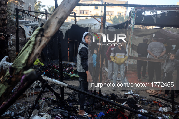 Displaced Palestinians check the damage following an Israeli strike that hits tents in Deir el-Balah in the central Gaza Strip on November 1...