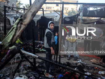 Displaced Palestinians check the damage following an Israeli strike that hits tents in Deir el-Balah in the central Gaza Strip on November 1...