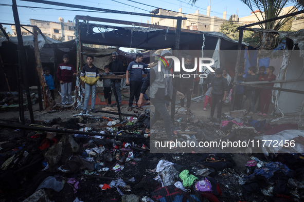 Displaced Palestinians check the damage following an Israeli strike that hits tents in Deir el-Balah in the central Gaza Strip on November 1...