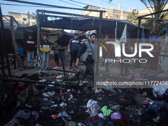 Displaced Palestinians check the damage following an Israeli strike that hits tents in Deir el-Balah in the central Gaza Strip on November 1...