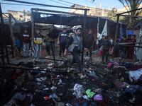 Displaced Palestinians check the damage following an Israeli strike that hits tents in Deir el-Balah in the central Gaza Strip on November 1...