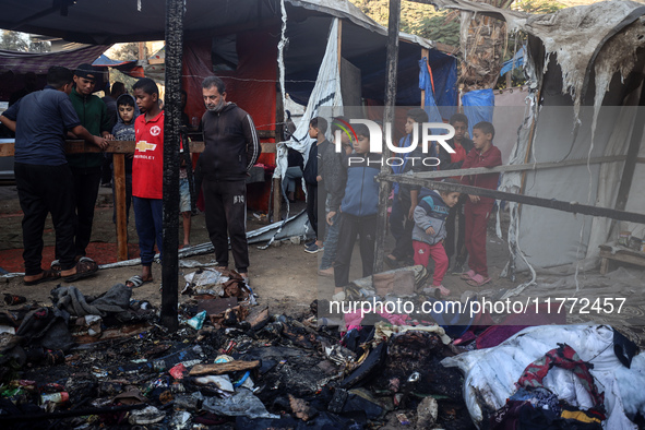 Displaced Palestinians check the damage following an Israeli strike that hits tents in Deir el-Balah in the central Gaza Strip on November 1...