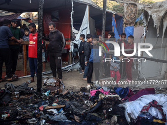 Displaced Palestinians check the damage following an Israeli strike that hits tents in Deir el-Balah in the central Gaza Strip on November 1...