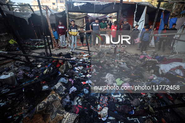 Displaced Palestinians check the damage following an Israeli strike that hits tents in Deir el-Balah in the central Gaza Strip on November 1...