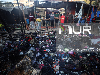 Displaced Palestinians check the damage following an Israeli strike that hits tents in Deir el-Balah in the central Gaza Strip on November 1...