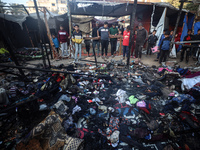 Displaced Palestinians check the damage following an Israeli strike that hits tents in Deir el-Balah in the central Gaza Strip on November 1...