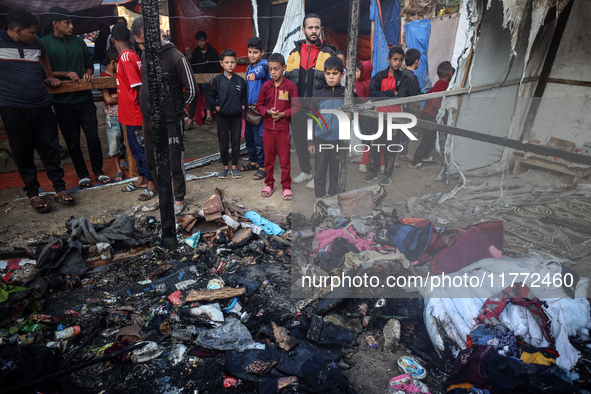 Displaced Palestinians check the damage following an Israeli strike that hits tents in Deir el-Balah in the central Gaza Strip on November 1...