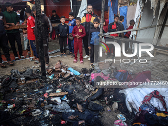 Displaced Palestinians check the damage following an Israeli strike that hits tents in Deir el-Balah in the central Gaza Strip on November 1...