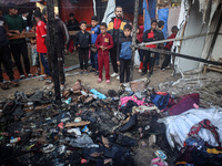 Displaced Palestinians check the damage following an Israeli strike that hits tents in Deir el-Balah in the central Gaza Strip on November 1...