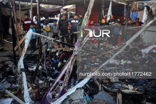 Displaced Palestinians check the damage following an Israeli strike that hits tents in Deir el-Balah in the central Gaza Strip on November 1...