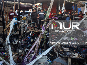 Displaced Palestinians check the damage following an Israeli strike that hits tents in Deir el-Balah in the central Gaza Strip on November 1...