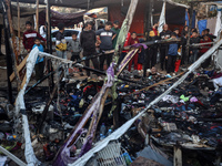 Displaced Palestinians check the damage following an Israeli strike that hits tents in Deir el-Balah in the central Gaza Strip on November 1...