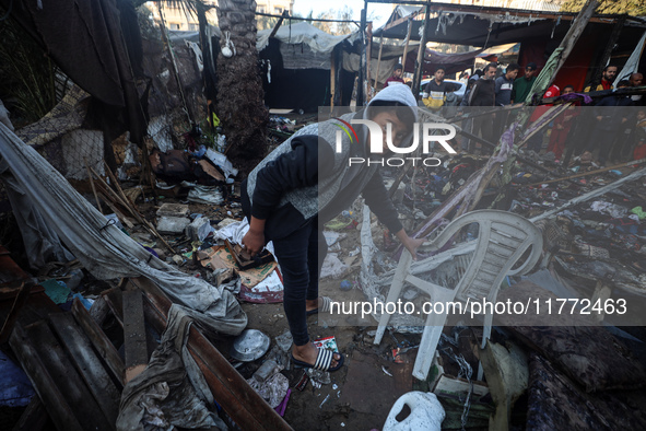 Displaced Palestinians check the damage following an Israeli strike that hits tents in Deir el-Balah in the central Gaza Strip on November 1...