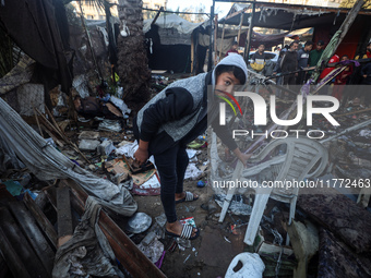 Displaced Palestinians check the damage following an Israeli strike that hits tents in Deir el-Balah in the central Gaza Strip on November 1...