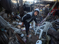 Displaced Palestinians check the damage following an Israeli strike that hits tents in Deir el-Balah in the central Gaza Strip on November 1...