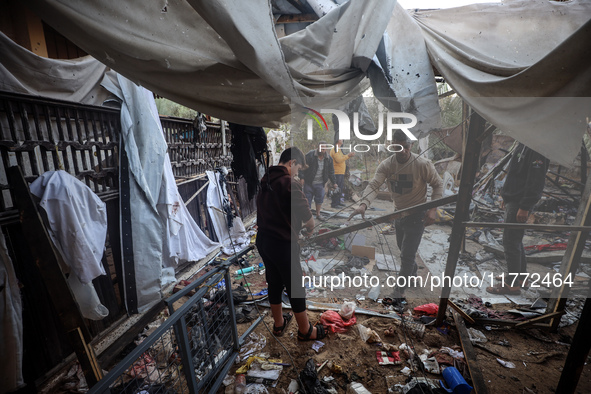 Displaced Palestinians check the damage following an Israeli strike that hits tents in Deir el-Balah in the central Gaza Strip on November 1...