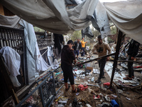 Displaced Palestinians check the damage following an Israeli strike that hits tents in Deir el-Balah in the central Gaza Strip on November 1...