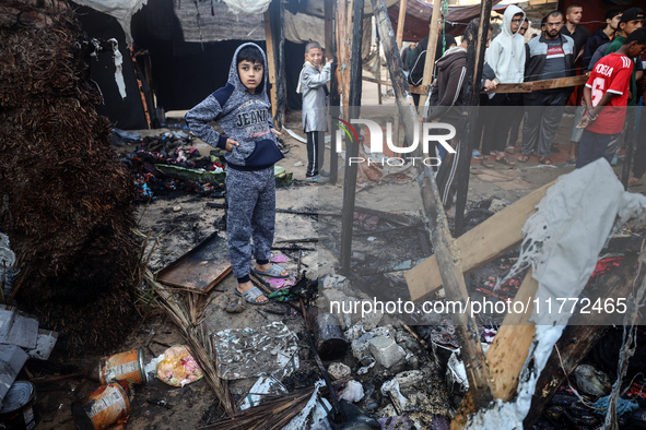 Displaced Palestinians check the damage following an Israeli strike that hits tents in Deir el-Balah in the central Gaza Strip on November 1...