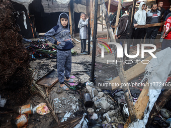 Displaced Palestinians check the damage following an Israeli strike that hits tents in Deir el-Balah in the central Gaza Strip on November 1...