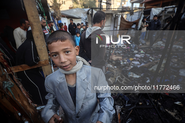 Displaced Palestinians check the damage following an Israeli strike that hits tents in Deir el-Balah in the central Gaza Strip on November 1...