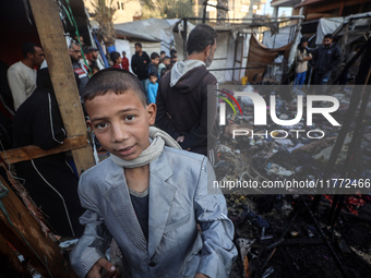 Displaced Palestinians check the damage following an Israeli strike that hits tents in Deir el-Balah in the central Gaza Strip on November 1...