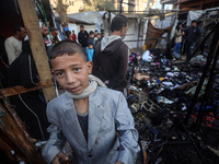 Displaced Palestinians check the damage following an Israeli strike that hits tents in Deir el-Balah in the central Gaza Strip on November 1...