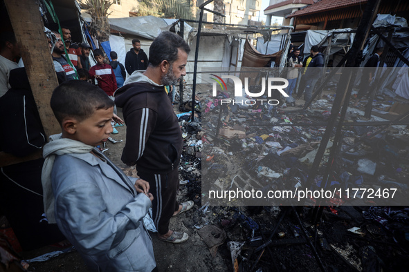 Displaced Palestinians check the damage following an Israeli strike that hits tents in Deir el-Balah in the central Gaza Strip on November 1...