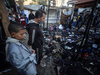 Displaced Palestinians check the damage following an Israeli strike that hits tents in Deir el-Balah in the central Gaza Strip on November 1...