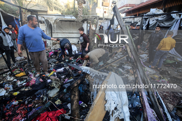 Displaced Palestinians check the damage following an Israeli strike that hits tents in Deir el-Balah in the central Gaza Strip on November 1...