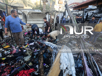 Displaced Palestinians check the damage following an Israeli strike that hits tents in Deir el-Balah in the central Gaza Strip on November 1...