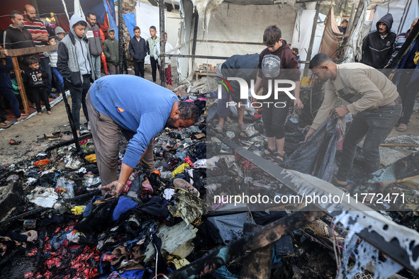 Displaced Palestinians check the damage following an Israeli strike that hits tents in Deir el-Balah in the central Gaza Strip on November 1...