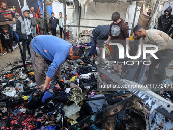 Displaced Palestinians check the damage following an Israeli strike that hits tents in Deir el-Balah in the central Gaza Strip on November 1...