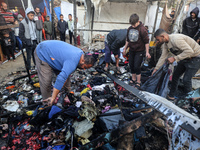 Displaced Palestinians check the damage following an Israeli strike that hits tents in Deir el-Balah in the central Gaza Strip on November 1...