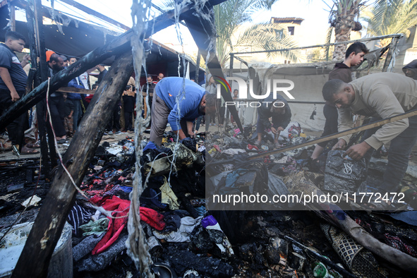 Displaced Palestinians check the damage following an Israeli strike that hits tents in Deir el-Balah in the central Gaza Strip on November 1...