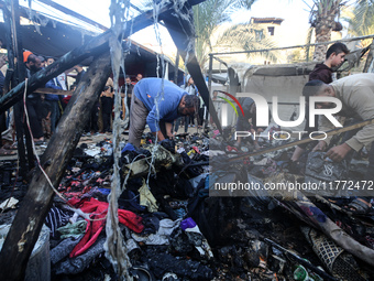 Displaced Palestinians check the damage following an Israeli strike that hits tents in Deir el-Balah in the central Gaza Strip on November 1...