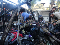 Displaced Palestinians check the damage following an Israeli strike that hits tents in Deir el-Balah in the central Gaza Strip on November 1...