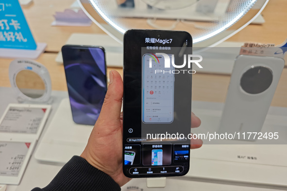 A user experiences Honor's newly released Maigic7 mobile phone at the Honor Mobile store in Shanghai, China, on November 13, 2024. 