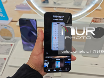 A user experiences Honor's newly released Maigic7 mobile phone at the Honor Mobile store in Shanghai, China, on November 13, 2024. (