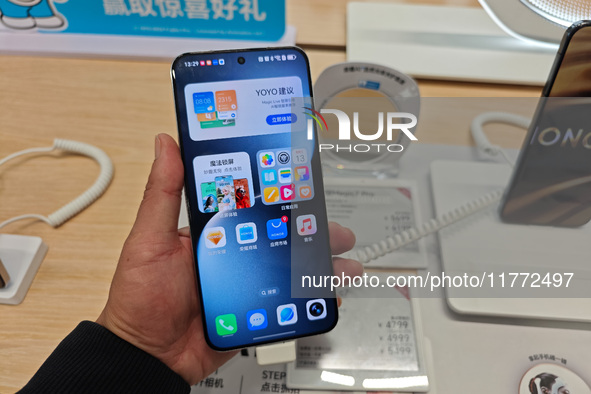 A user experiences Honor's newly released Maigic7 mobile phone at the Honor Mobile store in Shanghai, China, on November 13, 2024. 