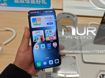 A user experiences Honor's newly released Maigic7 mobile phone at the Honor Mobile store in Shanghai, China, on November 13, 2024. (