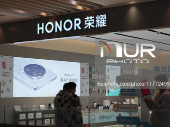 A user experiences Honor's newly released Maigic7 mobile phone at the Honor Mobile store in Shanghai, China, on November 13, 2024. (