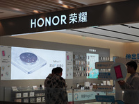 A user experiences Honor's newly released Maigic7 mobile phone at the Honor Mobile store in Shanghai, China, on November 13, 2024. (