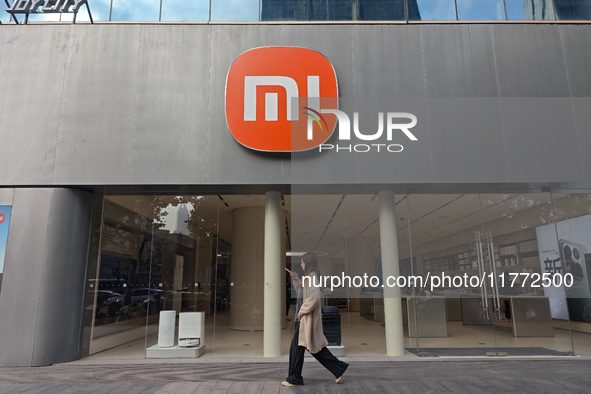 A pedestrian passes the Xiaomi store in Shanghai, China, on November 13, 2024. 