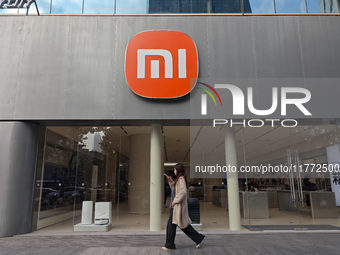 A pedestrian passes the Xiaomi store in Shanghai, China, on November 13, 2024. (