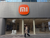 A pedestrian passes the Xiaomi store in Shanghai, China, on November 13, 2024. (