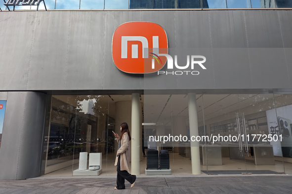 A pedestrian passes the Xiaomi store in Shanghai, China, on November 13, 2024. 